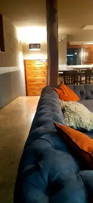a large blue couch in a room with a table at Bucanaan hostel boutique in Cordoba