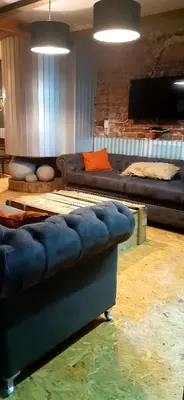 a living room with a couch and a television at Bucanaan hostel boutique in Cordoba