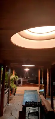 a large room with a large ceiling with a pool at Bucanaan hostel boutique in Cordoba