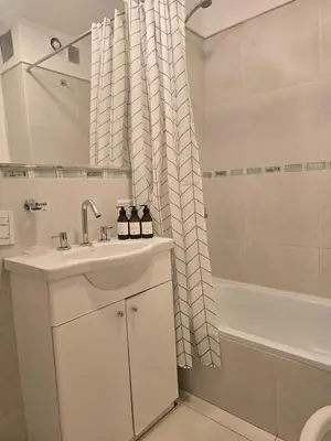 a bathroom with a sink and a shower curtain at Departamentos Illia By Lugar in Cordoba