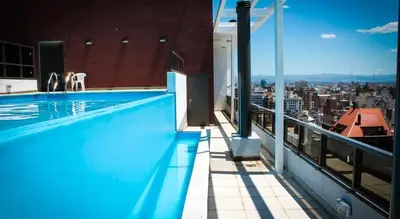 a swimming pool on the roof of a building at Departamentos Illia By Lugar in Cordoba