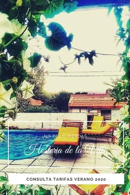 a picture of a pool with a bench and a bird at Hosteria de la Villa ** in Villa Cura Brochero