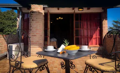 a table with a bowl of bananas on a patio at Hostal Las Golondrinas in Bialet Massé