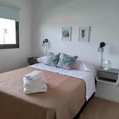 a bedroom with a bed with towels on it at Departamento Avani, nuevo A ESTRENAR, GIMNASIO Y SUM in Cordoba