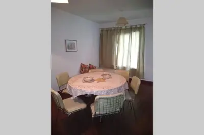 a dining room with a table and chairs at DEPARTAMENTO KRISTINA in Villa Carlos Paz