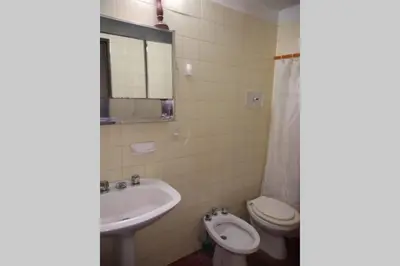a bathroom with a toilet and a sink at DEPARTAMENTO KRISTINA in Villa Carlos Paz