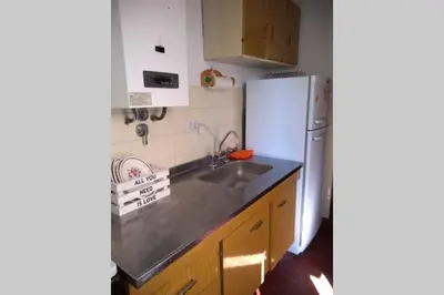 a kitchen with a sink and a refrigerator at DEPARTAMENTO KRISTINA in Villa Carlos Paz