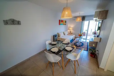 a living room with a table and chairs and a couch at Río Cuarto Host in Río Cuarto