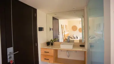a bathroom with a sink and a large mirror at Amardecer - Casa Boutique in Merlo