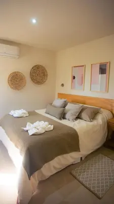 a bedroom with two beds with towels on them at Amardecer - Casa Boutique in Merlo