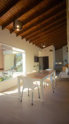 a dining table and chairs in a living room at Amardecer - Casa Boutique in Merlo