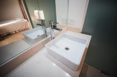 a bathroom with a white sink and a mirror at Amardecer - Casa Boutique in Merlo