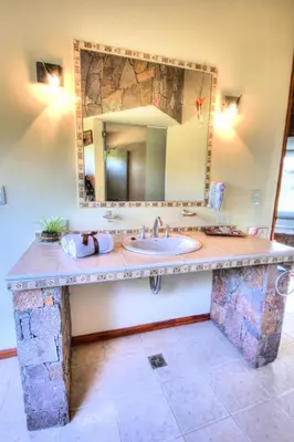 a bathroom with a sink and a mirror at Balcones de La Cumbrecita in La Cumbrecita