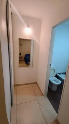 a bathroom with a toilet and a mirror at Excelente SEMIPISO vista al Buen Pastor in Cordoba