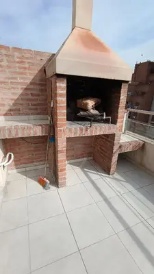 an outdoor pizza oven on top of a roof at Excelente SEMIPISO vista al Buen Pastor in Cordoba