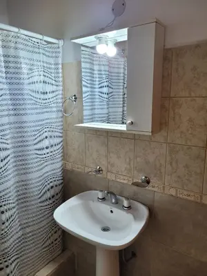a bathroom with a sink and a mirror at Nuova Costa Cabañas in Los Molles