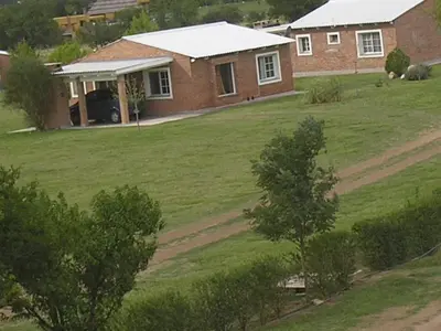 a house with a large yard in front of it at El Mirador de Nono in Nono