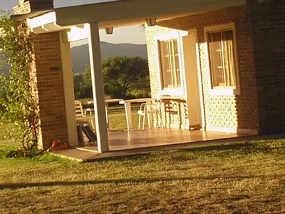 a porch with a deck with a table and chairs at El Mirador de Nono in Nono