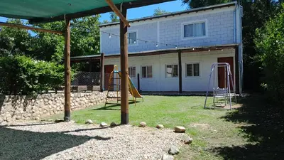 a backyard with a swing set and a playground at Cabañas El Nogal in Villa Anizacate
