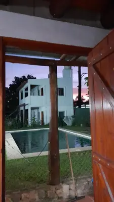 a view of a house and a pool with a building at Cabañas El Nogal in Villa Anizacate