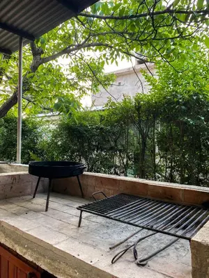 a grill sitting on a table on a patio at Cabañas El Nogal in Villa Anizacate