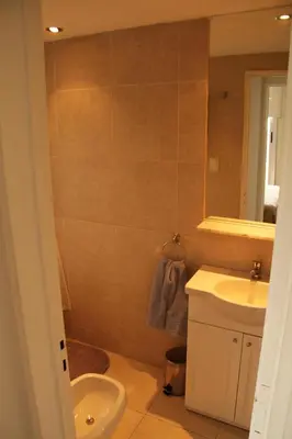 a bathroom with a sink and a toilet and a mirror at Cordoba Rent Centro Avellaneda in Cordoba