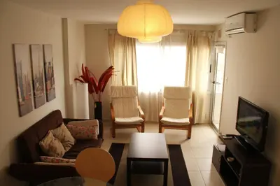 a living room with a couch and chairs and a television at Cordoba Rent Centro Avellaneda in Cordoba