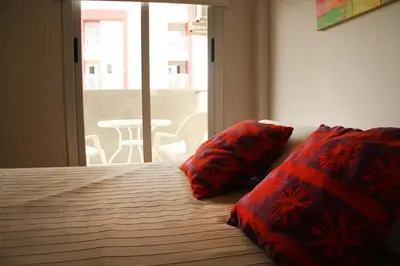 a bedroom with a bed with two red pillows on it at Cordoba Rent Centro Avellaneda in Cordoba
