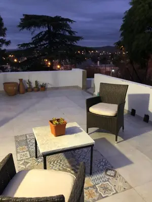 a patio with two chairs and a table and a table at URBANO TAJAMAR in Alta Gracia