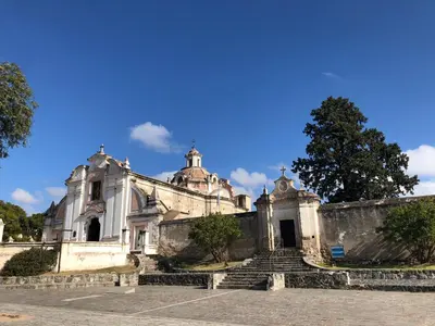 an old church with stairs in front of it at URBANO TAJAMAR in Alta Gracia