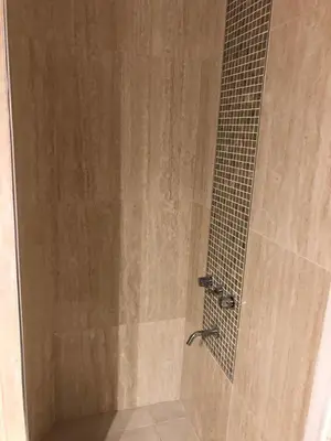 a shower stall with a shower at URBANO TAJAMAR in Alta Gracia