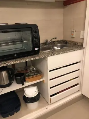 a kitchen with a sink and a microwave at URBANO TAJAMAR in Alta Gracia