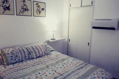 a bed with a quilt on it in a bedroom at Nuevocentro Modern in Cordoba