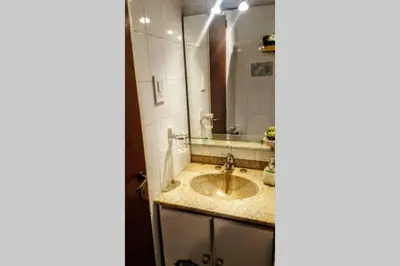 a bathroom with a sink and a mirror at Nuevocentro Modern in Cordoba