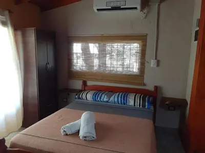 a bedroom with a bed with a towel on it at Cabañas Ecos del Valle in Los Reartes