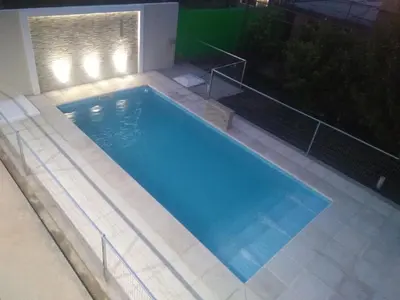 a large swimming pool with lights on top of it at Complejo Belu in Santa Rosa de Calamuchita