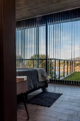 a room with a bed and a large window at LUNALBA in Potrero de Garay
