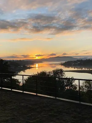a sunset over a body of water with a fence at LUNALBA in Potrero de Garay