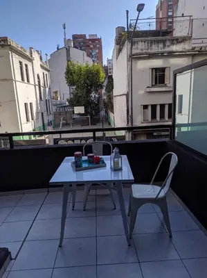 a table and a chair on a balcony at Departamento 2 dormitorios Nueva Cordoba in Cordoba