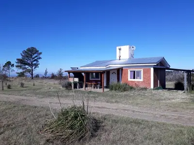 a small house in the middle of a field at Alas Mágicas in Villa Yacanto