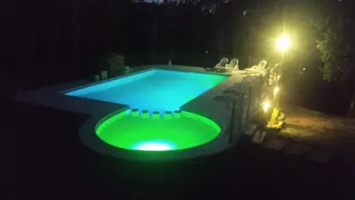 a swimming pool at night with a green glow at Departamento Cerro Negro in Villa General Belgrano