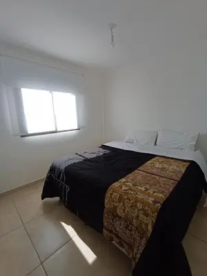 a bedroom with a bed in a room with a window at Alto Tucumán in Cordoba