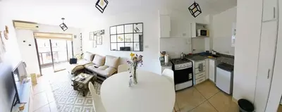a kitchen and living room with a couch and a table at Alto Tucumán in Cordoba