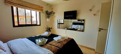 a bedroom with a bed with towels on it at Alto Tucumán in Cordoba
