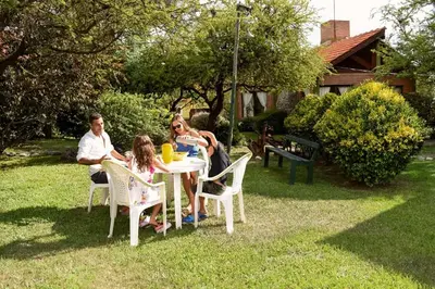 a family sitting at a table in a yard at La Morada in Merlo