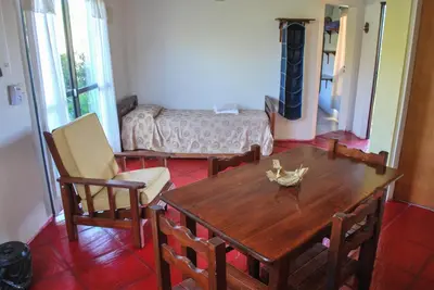 a dining room with a wooden table and chairs at La Morada in Merlo