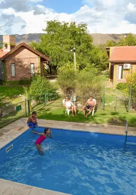 a group of people playing in a swimming pool at La Morada in Merlo