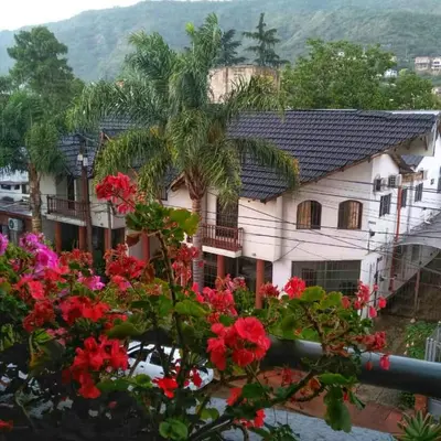 a house with flowers in front of it at Lion D`Or in Villa Carlos Paz