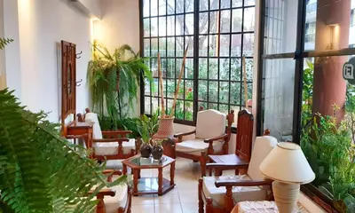 a large room with chairs and tables and windows at Lion D`Or in Villa Carlos Paz