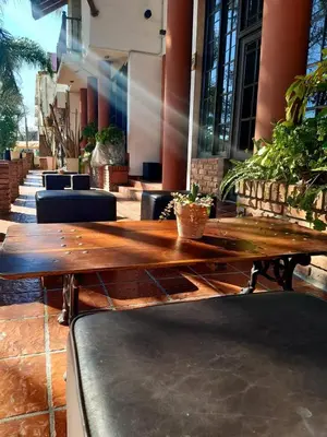 a wooden table sitting in front of a building at Lion D`Or in Villa Carlos Paz